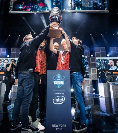 The Players standing on stage with holds a Winning Cup