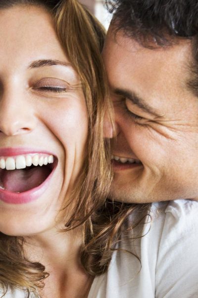 A Couple smiling & Holding each other