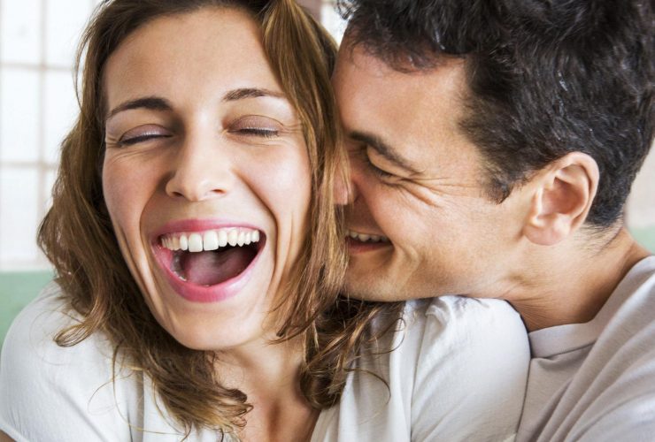 A Couple smiling & Holding each other