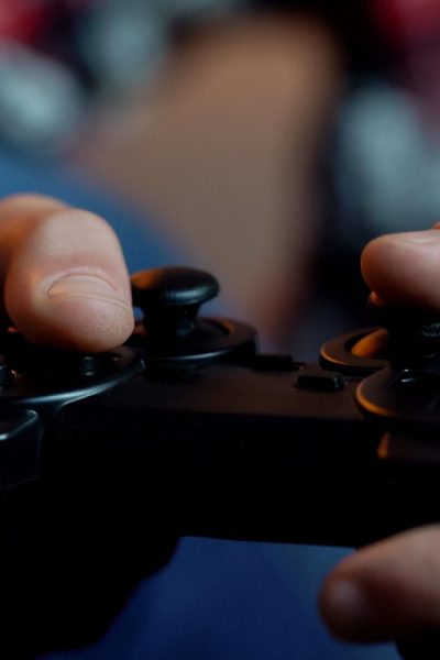 A hand holding a remote control