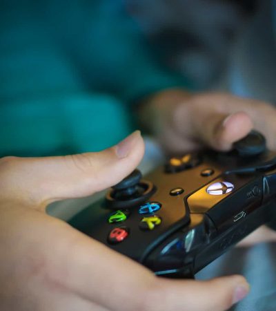 A hand holding a remote control